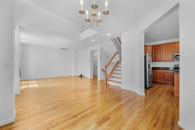 19 Woodrose Ct, Middletown, NY 10940 - unfurnished living room featuring stairway, a chandelier, light wood finished floors, baseboards, and recessed lighting