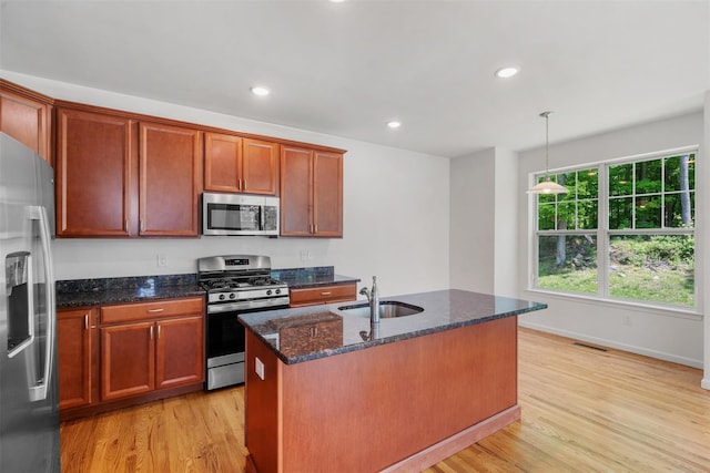 19 Woodrose Ct, Middletown, NY 10940 - kitchen featuring stainless steel appliances, light wood-style flooring, a sink, dark stone counters, and recessed lighting