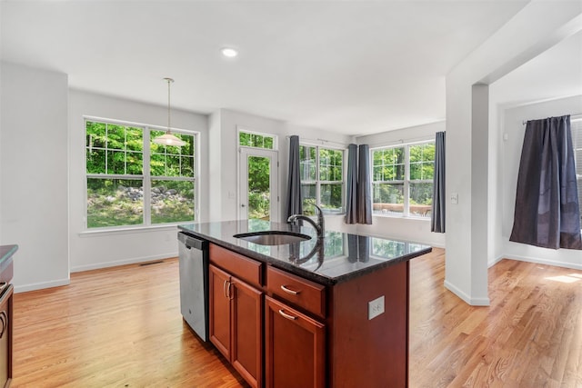 19 Woodrose Ct, Middletown, NY 10940 - kitchen featuring stainless steel dishwasher, light wood-type flooring, a sink, dark stone counters, and baseboards