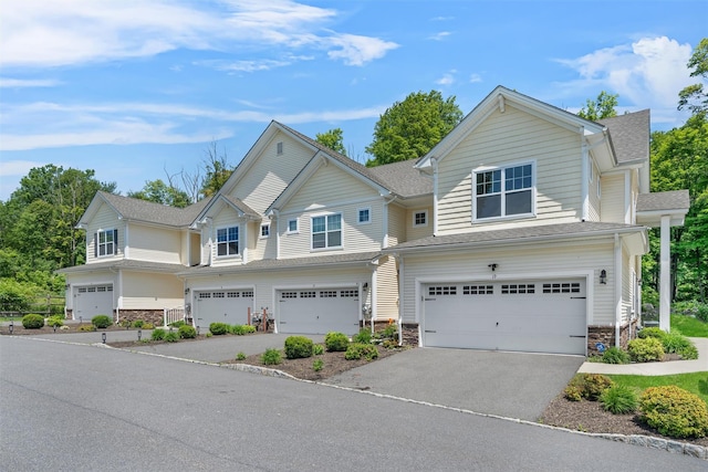 19 Woodrose Ct, Middletown, NY 10940 - view of front facade featuring stone siding, a garage, driveway, and a shingled roof