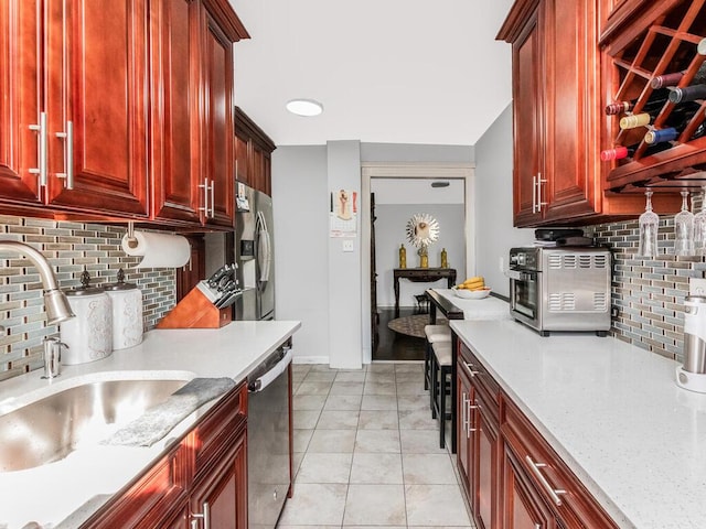 1234 Midland Ave Unit 5C, Bronxville, NY 10708 - kitchen with reddish brown cabinets, stainless steel appliances, a sink, and backsplash