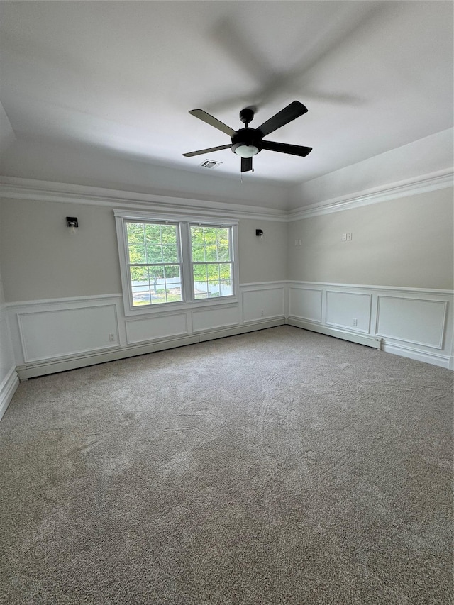 20 Frost Valley Rd, Mount Sinai, NY 11766 - empty room with carpet flooring, a decorative wall, a ceiling fan, a wainscoted wall, and ornamental molding