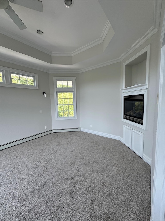 20 Frost Valley Rd, Mount Sinai, NY 11766 - unfurnished living room featuring a tray ceiling, carpet flooring, crown molding, ceiling fan, and a glass covered fireplace