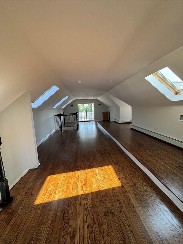 20 Frost Valley Rd, Mount Sinai, NY 11766 - additional living space featuring a skylight, baseboard heating, lofted ceiling, wood finished floors, and baseboards