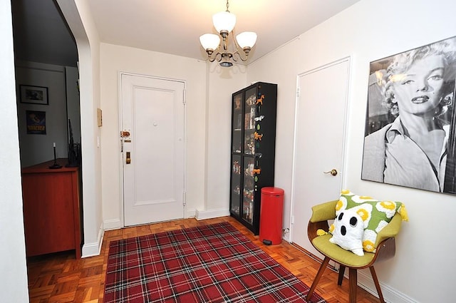 142 Garth Rd Unit 1A, Scarsdale, NY 10583 - entrance foyer with a chandelier, baseboards, and arched walkways