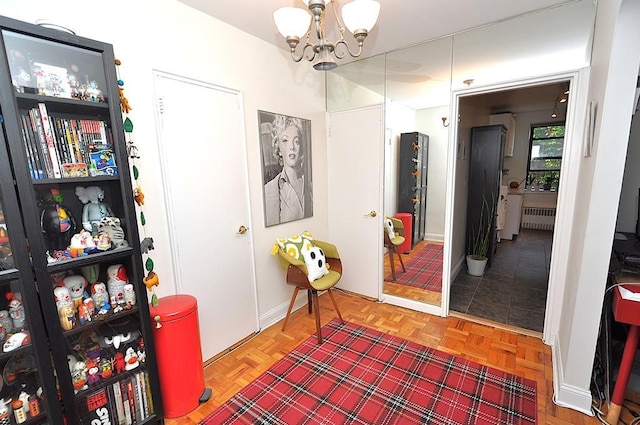 142 Garth Rd Unit 1A, Scarsdale, NY 10583 - corridor with a chandelier, radiator heating unit, and baseboards