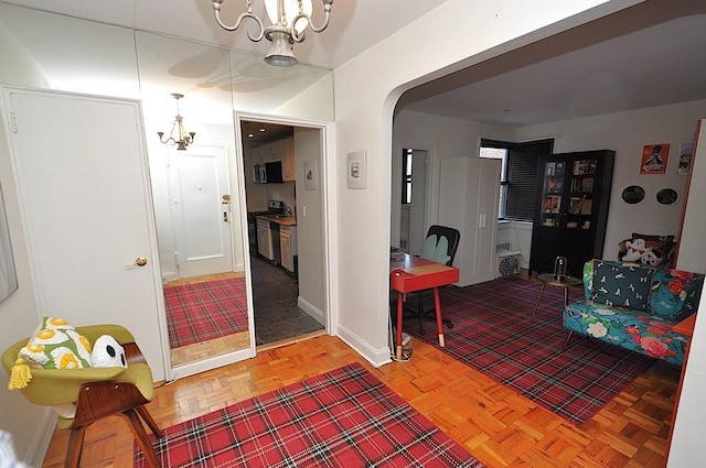 142 Garth Rd Unit 1A, Scarsdale, NY 10583 - entrance foyer with a chandelier, arched walkways, and baseboards