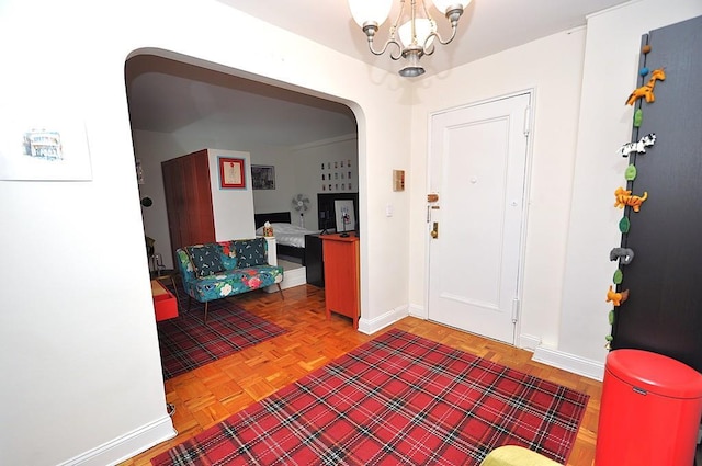 142 Garth Rd Unit 1A, Scarsdale, NY 10583 - foyer featuring a chandelier, baseboards, and arched walkways