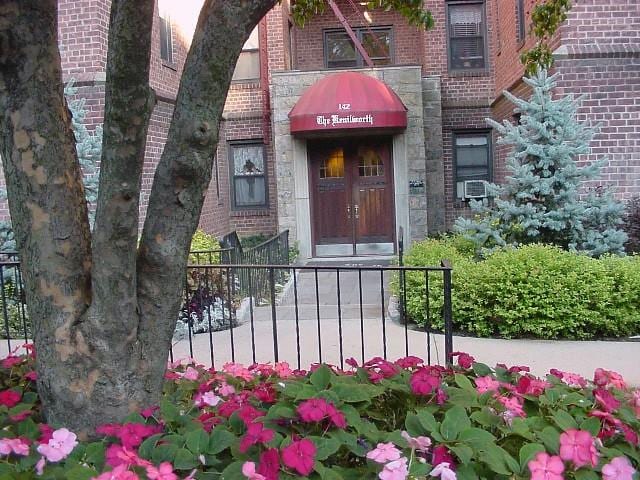142 Garth Rd Unit 1A, Scarsdale, NY 10583 - view of exterior entry featuring brick siding and cooling unit