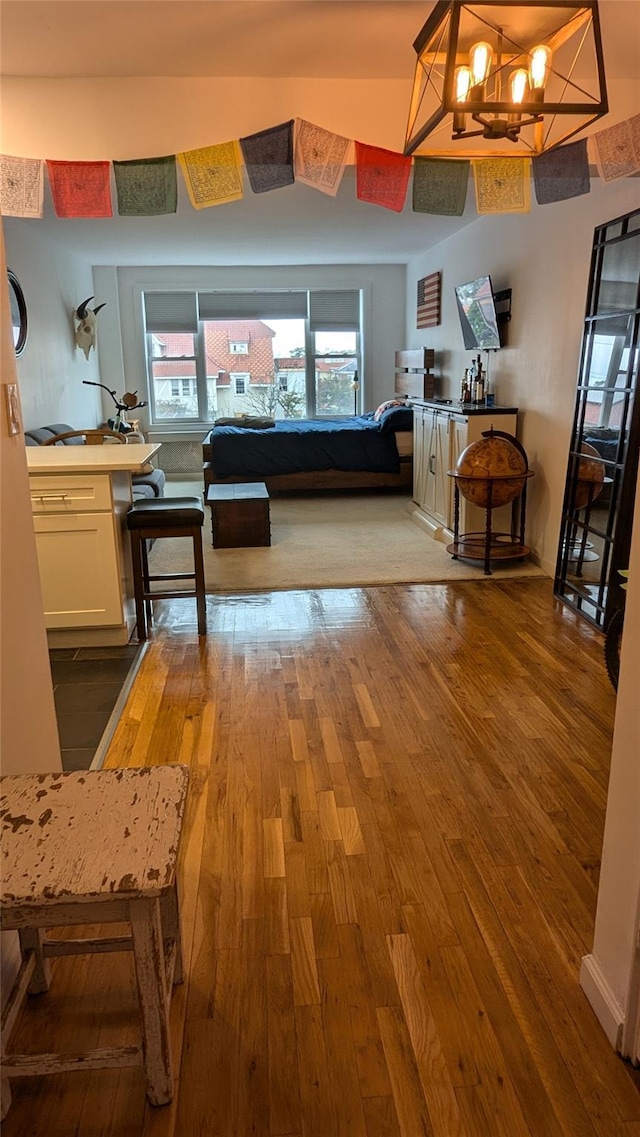 1 E Broadway Unit 3R, Long Beach, NY 11561 - bedroom with hardwood / wood-style flooring and a chandelier