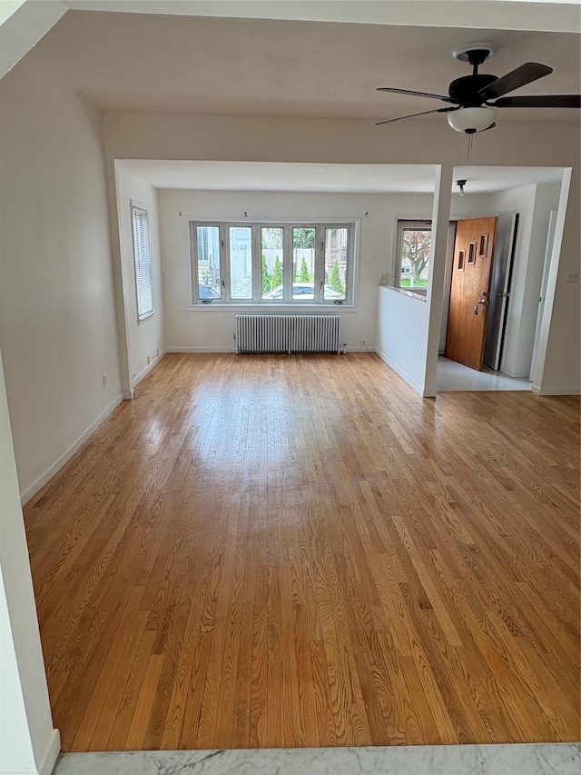 840 Hollywood Ave, Bronx, NY 10465 - spare room featuring radiator, light wood-style flooring, a ceiling fan, and baseboards