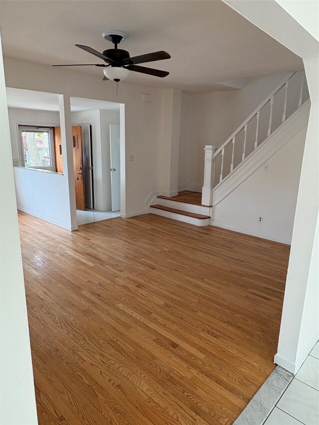 840 Hollywood Ave, Bronx, NY 10465 - spare room with stairs, wood finished floors, a ceiling fan, and baseboards