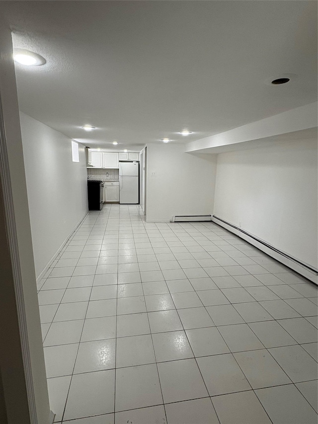 840 Hollywood Ave, Bronx, NY 10465 - finished below grade area with freestanding refrigerator, baseboard heating, light tile patterned flooring, baseboards, and recessed lighting
