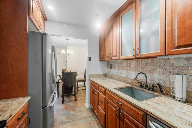 67 Richmond Blvd Unit 2A, Ronkonkoma, NY 11779 - kitchen with stainless steel appliances, a sink, backsplash, a chandelier, and stone finish floors