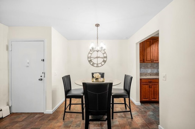 67 Richmond Blvd Unit 2A, Ronkonkoma, NY 11779 - dining space with a chandelier, baseboards, and stone finish flooring