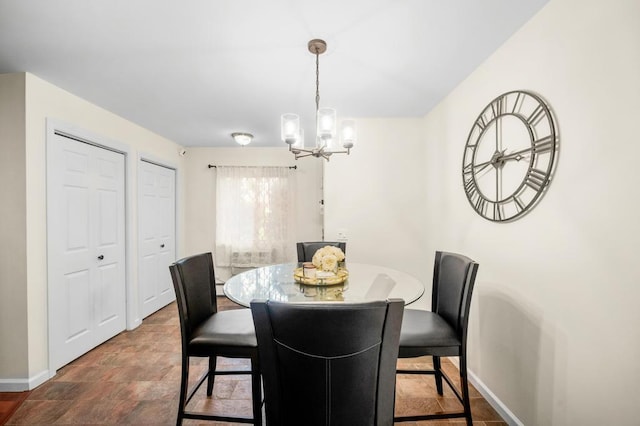 67 Richmond Blvd Unit 2A, Ronkonkoma, NY 11779 - dining space featuring baseboards, a chandelier, and stone finish floors