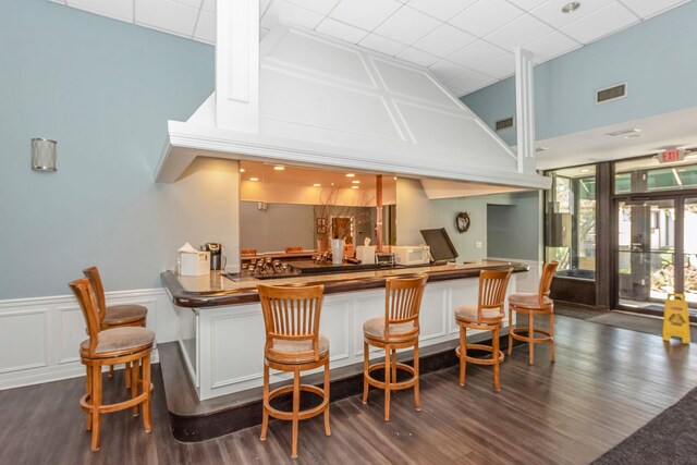 67 Richmond Blvd Unit 2A, Ronkonkoma, NY 11779 - indoor dry bar with a high ceiling, dark wood-style flooring, a wainscoted wall, and a decorative wall