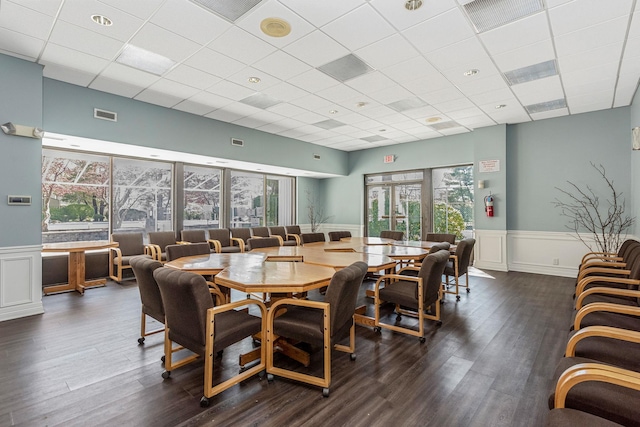 67 Richmond Blvd Unit 2A, Ronkonkoma, NY 11779 - dining room featuring a drop ceiling, a wainscoted wall, dark wood-type flooring, and a decorative wall