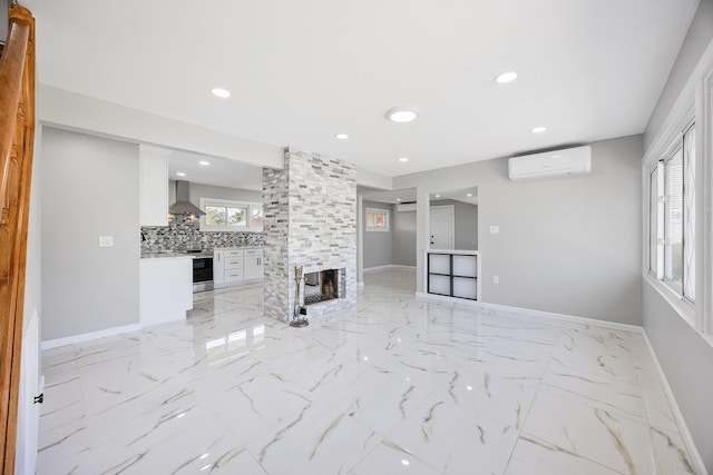 2 Starlight Ln, Levittown, NY 11756 - unfurnished living room with a wall mounted air conditioner, light marble finish floors, baseboards, a multi sided fireplace, and recessed lighting