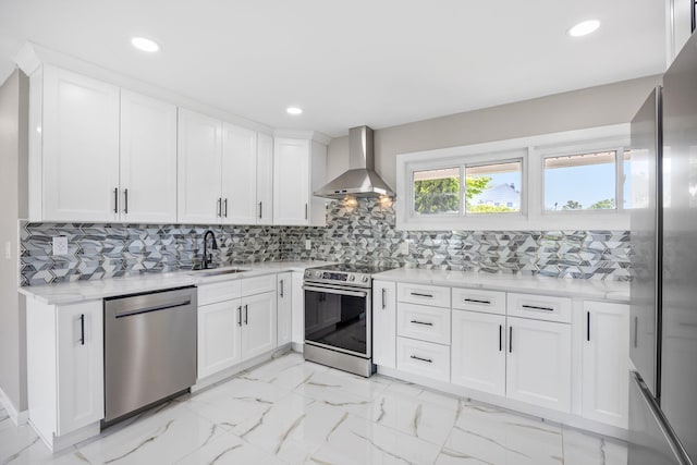 2 Starlight Ln, Levittown, NY 11756 - kitchen featuring wall chimney range hood, stainless steel appliances, a sink, light countertops, and light marble finish flooring