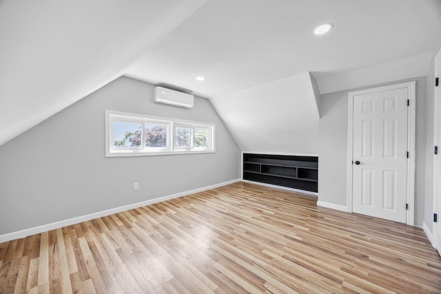 2 Starlight Ln, Levittown, NY 11756 - bonus room with a wall unit AC, light wood finished floors, baseboards, lofted ceiling, and recessed lighting
