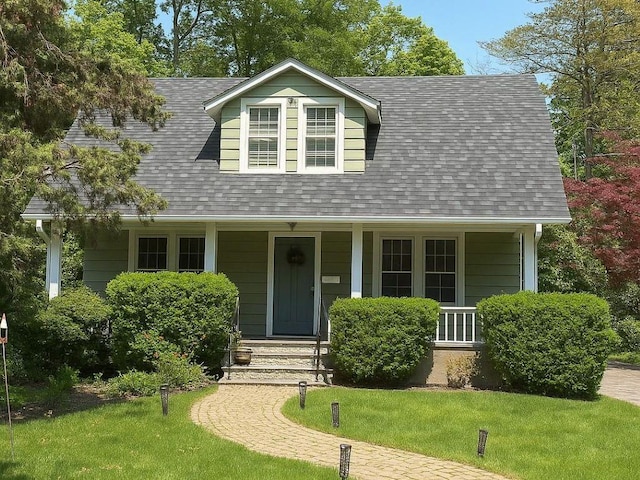 38 Winslow Rd, White Plains, NY 10606 - cape cod-style house with a front lawn, roof with shingles, and covered porch