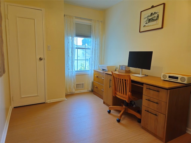 office area featuring baseboards and light wood-style flooring
