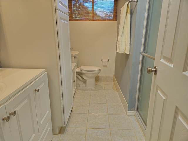 full bathroom featuring vanity, tile patterned flooring, a shower with door, and toilet