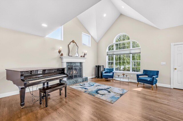 8 Tecumseh Ct, Commack, NY 11725 - living area featuring high vaulted ceiling, healthy amount of natural light, a high end fireplace, baseboards, and recessed lighting
