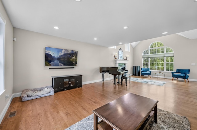 8 Tecumseh Ct, Commack, NY 11725 - living room featuring a fireplace, wood finished floors, baseboards, vaulted ceiling, and recessed lighting