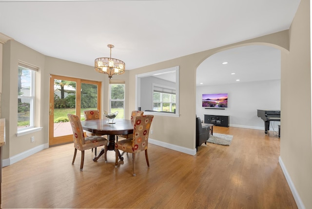 8 Tecumseh Ct, Commack, NY 11725 - dining space featuring arched walkways, light wood finished floors, a chandelier, baseboards, and recessed lighting