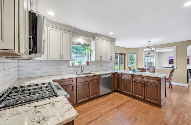 8 Tecumseh Ct, Commack, NY 11725 - kitchen with dishwasher, a sink, a peninsula, a chandelier, and light wood-type flooring