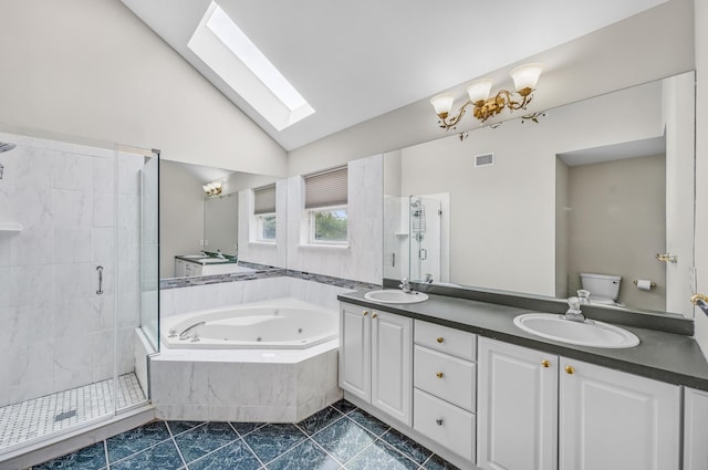 8 Tecumseh Ct, Commack, NY 11725 - bathroom with a skylight, a stall shower, a jetted tub, double vanity, and toilet