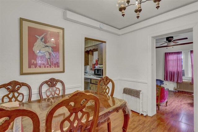 62 Herman Blvd, Franklin Square, NY 11010 - dining area with radiator heating unit, wood finished floors, and a chandelier