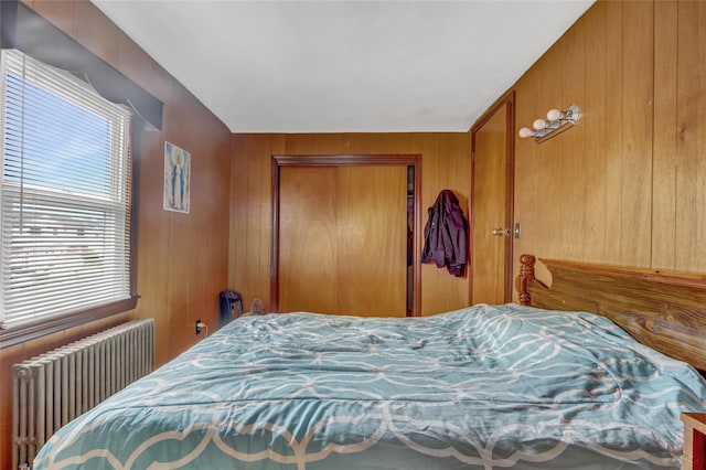 62 Herman Blvd, Franklin Square, NY 11010 - bedroom with radiator, a closet, and wooden walls