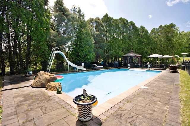 3060 State Route 17b, Cochecton, NY 12726 - view of pool featuring a gazebo, a water slide, a patio area, and view of wooded area