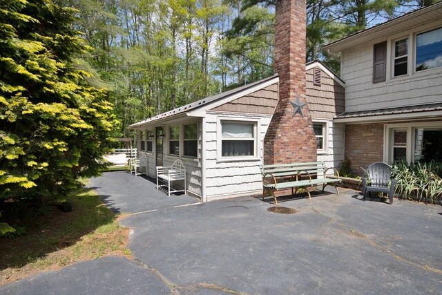 3060 State Route 17b, Cochecton, NY 12726 - view of side of home with a chimney and a patio