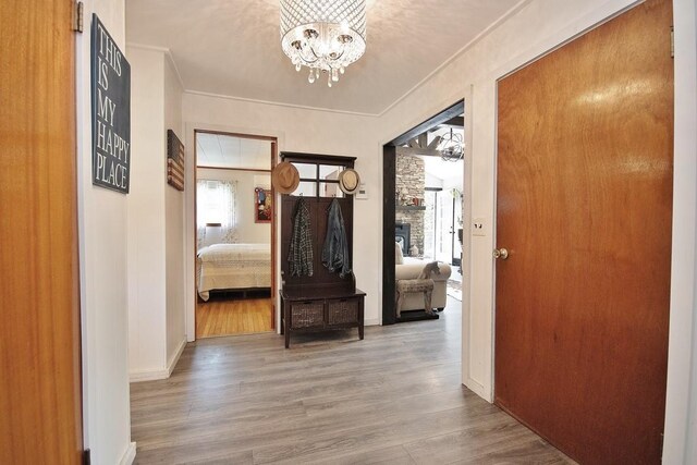 3060 State Route 17b, Cochecton, NY 12726 - hallway featuring a chandelier, wood finished floors, crown molding, and baseboards