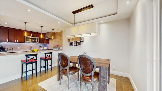 5-16 115th Unit C, College Point, NY 11356 - dining area featuring light wood-style floors, recessed lighting, a raised ceiling, and baseboards
