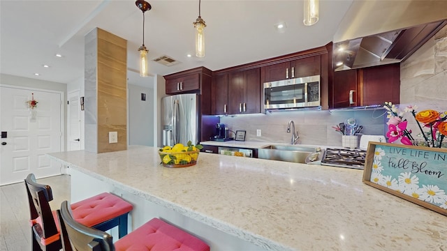 5-16 115th Unit C, College Point, NY 11356 - kitchen with appliances with stainless steel finishes, a sink, a peninsula, hanging light fixtures, and tasteful backsplash