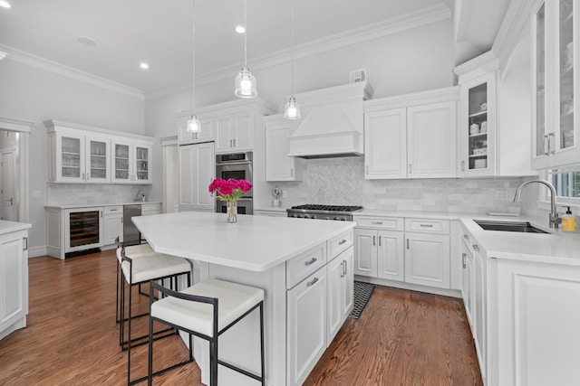 30 Salem Ridge Dr, Huntington, NY 11743 - kitchen featuring beverage cooler, a sink, custom range hood, white cabinetry, and crown molding