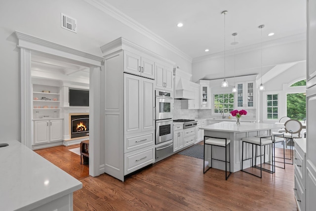 30 Salem Ridge Dr, Huntington, NY 11743 - kitchen with custom exhaust hood, a warming drawer, appliances with stainless steel finishes, light countertops, and ornamental molding