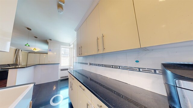 9410 64th Rd Unit B6, Rego Park, NY 11374 - kitchen with radiator, pendant lighting, and dark stone countertops