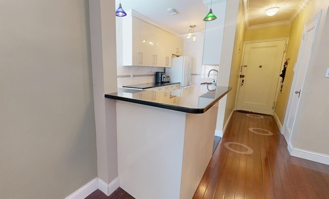 9410 64th Rd Unit B6, Rego Park, NY 11374 - kitchen featuring freestanding refrigerator, dark wood-style floors, crown molding, white cabinets, and a sink