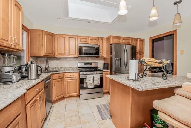 127 Parkview Rd, Elmsford, NY 10523 - kitchen with appliances with stainless steel finishes, a kitchen bar, tasteful backsplash, a skylight, and a sink