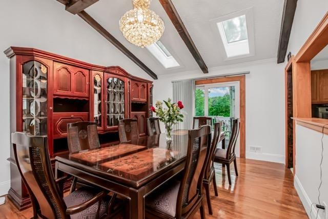 127 Parkview Rd, Elmsford, NY 10523 - dining space with a chandelier, a skylight, baseboards, and light wood-type flooring