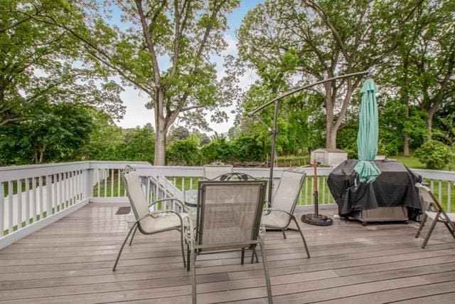 127 Parkview Rd, Elmsford, NY 10523 - deck with outdoor dining area, a grill, and view of scattered trees