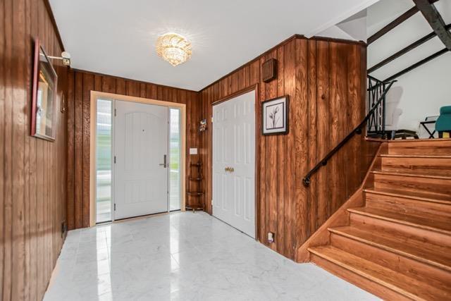 127 Parkview Rd, Elmsford, NY 10523 - entryway with stairs and wood walls