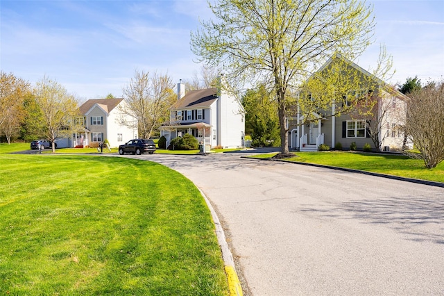 19 Bush Creek Ln, Poughquag, NY 12570 - view of front of property featuring a front lawn, a chimney, and a residential view