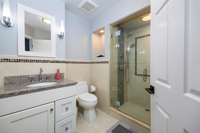 19 Bush Creek Ln, Poughquag, NY 12570 - full bathroom with a stall shower, vanity, toilet, tile walls, and tile patterned flooring